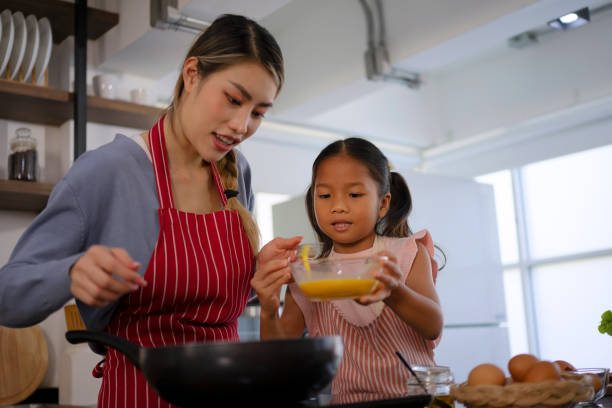 istock Mother and daughter make a meal at kitchen. 1536862161