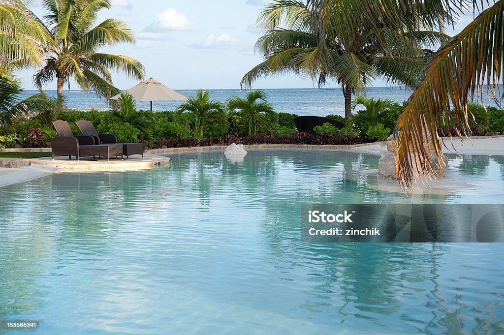 Hotel pool Hotel pool on a cloudy day with carribean sea on background Beach Stock Photo