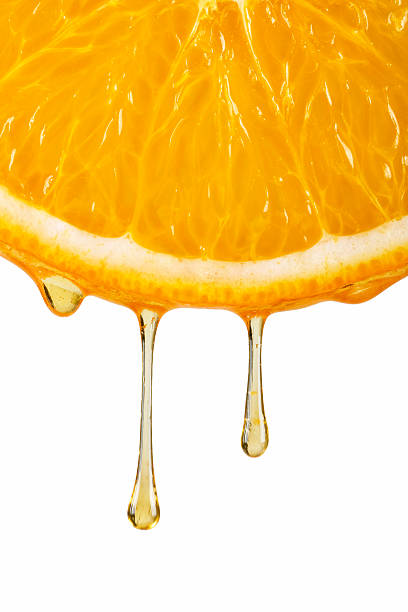 istock drops of orange juice 153686540