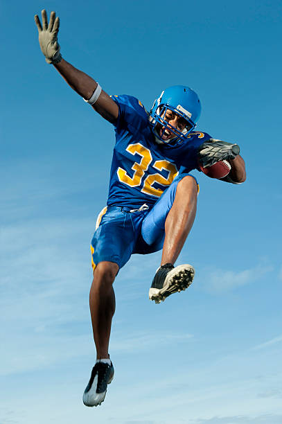 istock Football player jumping with ball 153686602