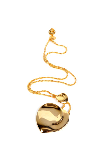 Large gold flower pendant necklace isolated on black background
