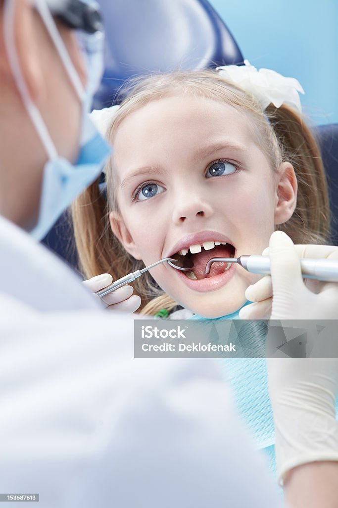 Dentistry Child examines the dentist in the clinic Adult Stock Photo