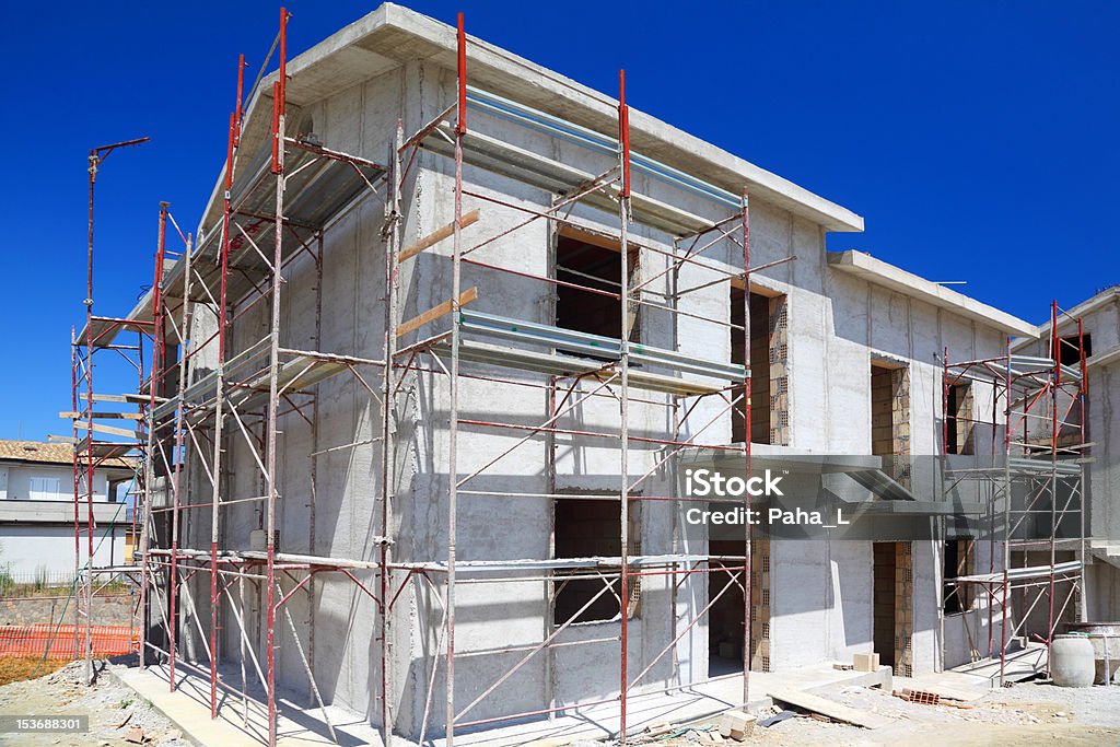 building of new two-story white concrete house Construction of building of new two-story white concrete house with stairs and balcony Architecture Stock Photo