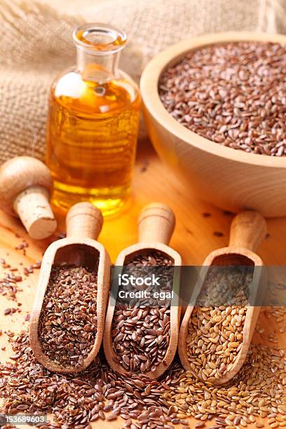 Linseed Oil And Flax Seeds Stock Photo - Download Image Now - Bottle, Bowl, Brown