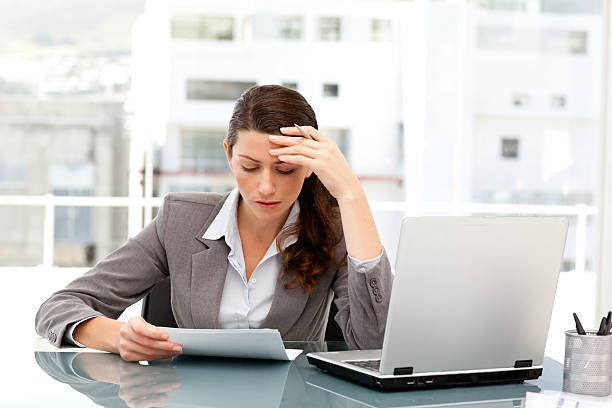 istock Pensive businesswoman looking at a paper while working 153689896