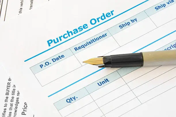 Blank printed copy of a purchase order with pen on it