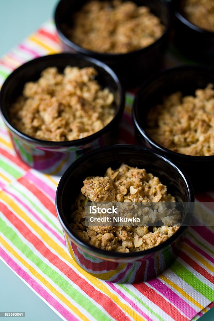 Home made apple crumble in black containers Apple - Fruit Stock Photo