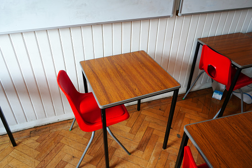 Red school classroom chairs and desks
