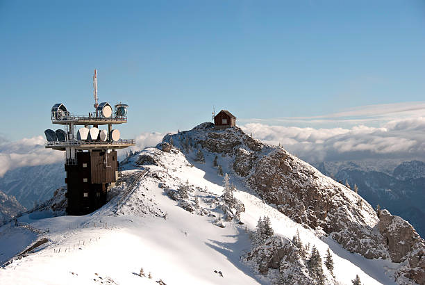 Winter Austrian Alps - telecommunication tower on top of snowy mountain