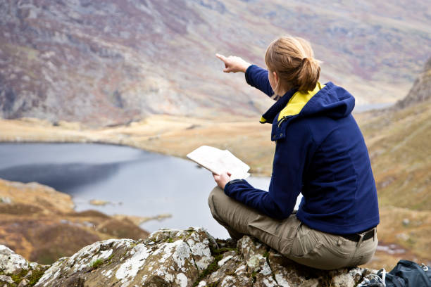 jeune femme pointant le trajet - wales snowdonia snowdonia national park mountain photos et images de collection