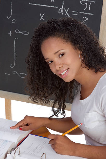 ethnic black college student woman studying math exam stock photo