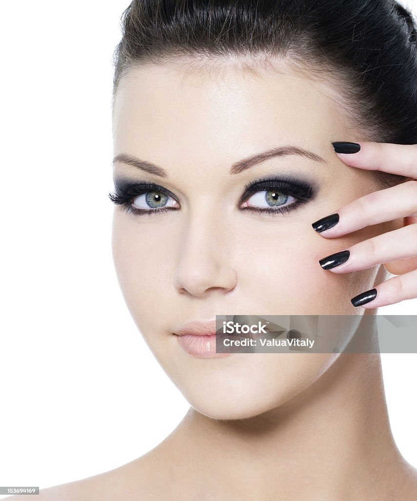 Woman's face with glamour make-up portrait of a young beautiful woman with fashion black make-up and manicure - isolated on white Black Color Stock Photo