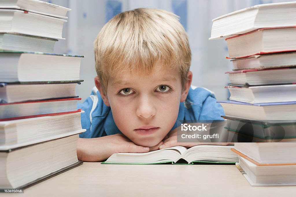 Boy at desk with books Blond Hair Stock Photo