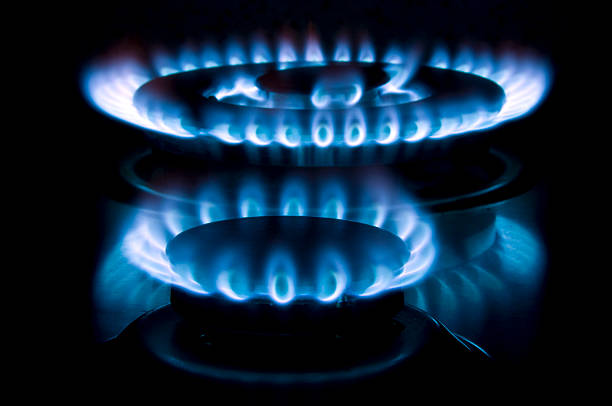 Two gas burners alight on a hob stock photo