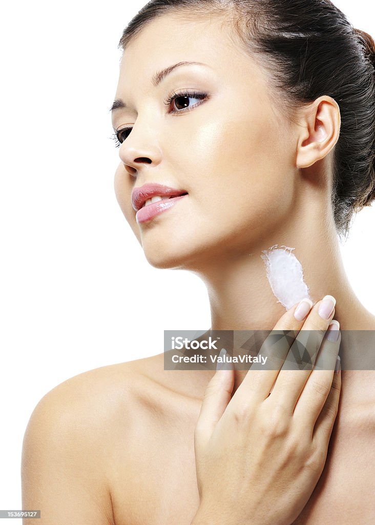 asian female  applying  moisturizer  cream on neck Beautiful asian female  applying cosmetic moisturizer  cream on neck Moisturizer Stock Photo