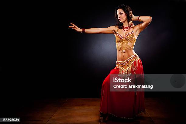 A Belly Dancer In Traditional Clothing In A Dark Studio Stock Photo - Download Image Now