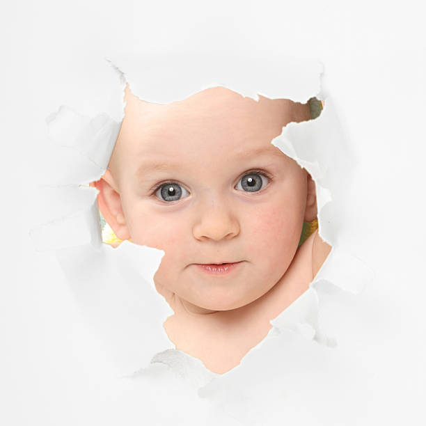 istock Cute baby looking through paper hole 153696645