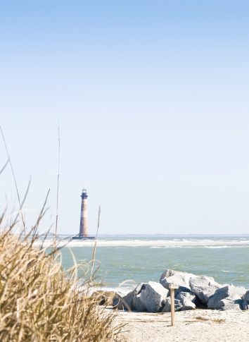 The Morris Island Lighthouse at one time stood on a barrier island.  A number of years ago the current around Charleston Harbor changed and began to erode the island.  Today the island is gone and the light sits on its foundation with the waves crashing about.