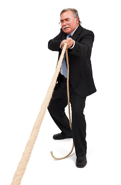 istock Senior business man pulling the rope hard 153696917