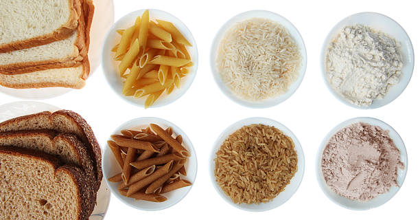 Brown vs. White Flour and Rice Products Whole Wheat Bread, Pasta, Flour and Brown Rice Vs. White Flour and Rice Products, Isolated, White whole wheat stock pictures, royalty-free photos & images