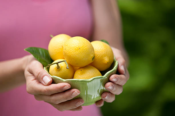 istock Woman holding Lemons 153697045