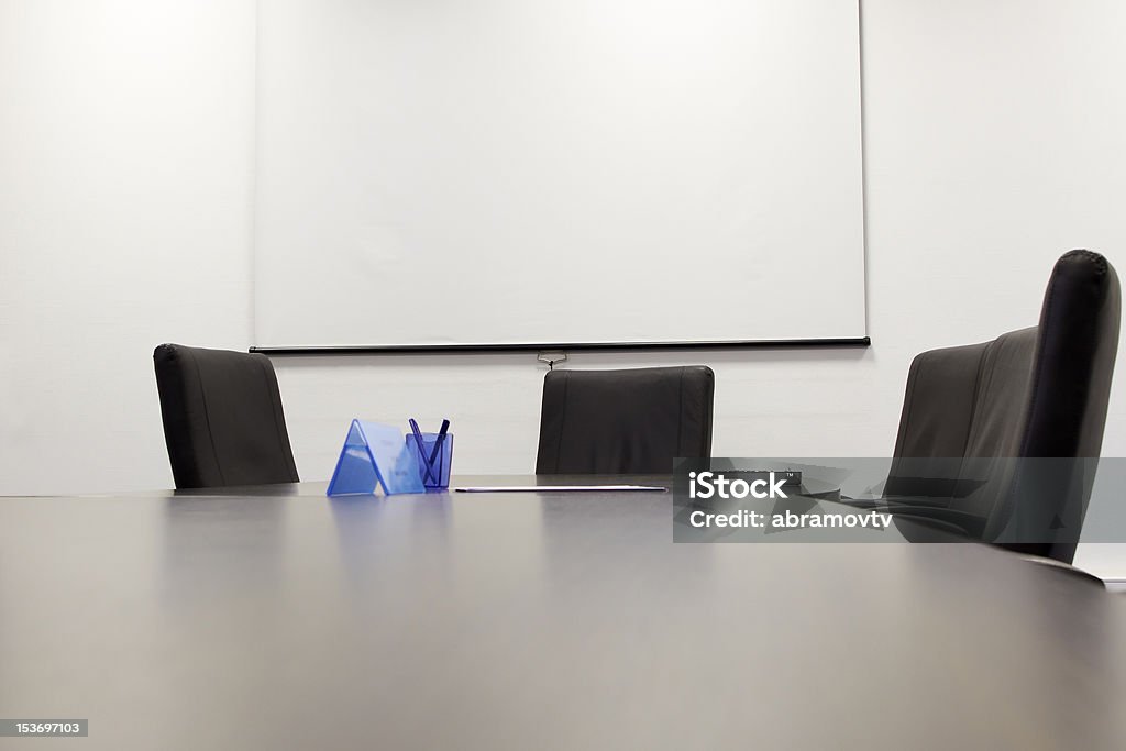 Conference Table Meeting Room with White Screen Ready for a Presentation Armchair Stock Photo