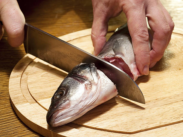istock Cutting of crude fish by a knife 153697114