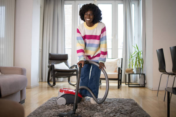 istock Woman cleaning floor with vacuum cleaner 1536973626