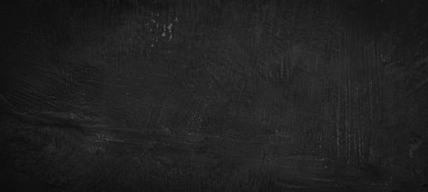 istock Dark black anthracite gray grey stone concrete texture wall facade plaster wallpaper tiles background banner 1536974688