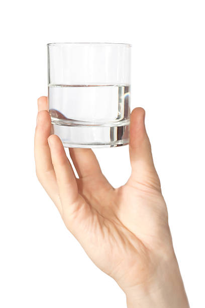 istock holding water glass in the hand 153697735