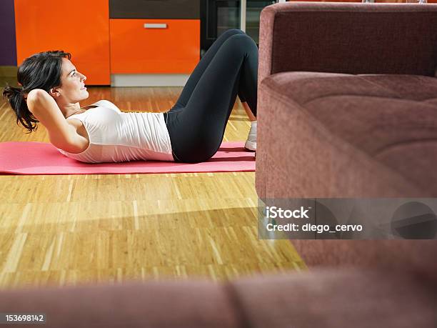 Woman Doing Exercising On A Pink Mat At Home Stock Photo - Download Image Now - 30-34 Years, 30-39 Years, Abdominal Muscle