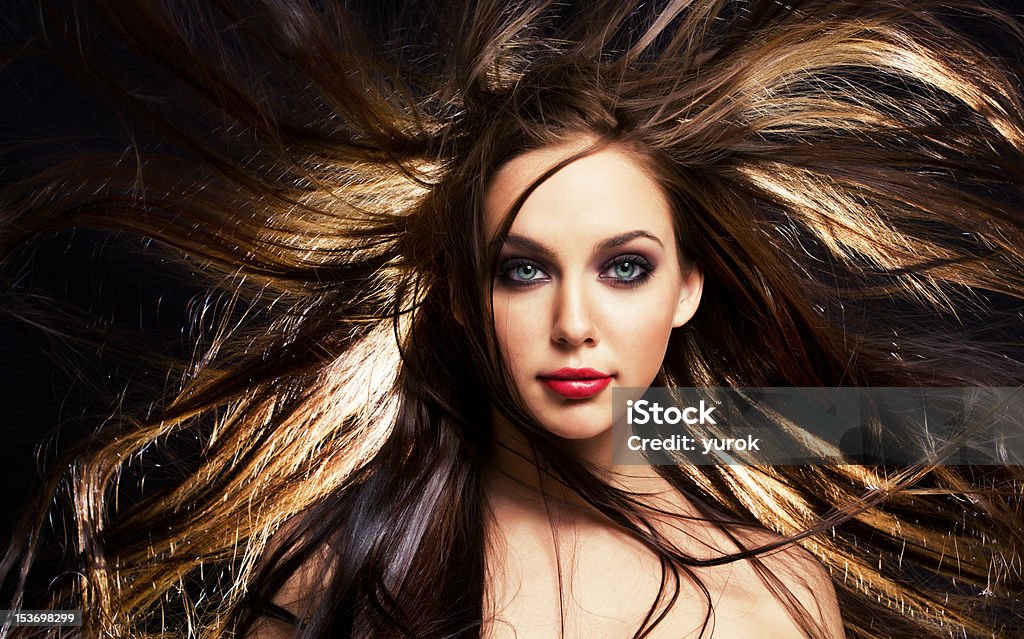hair in motion close up portrait of young brunette woman, with her hair in motion Adult Stock Photo