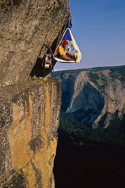Rock climber in his shelter. stock photo