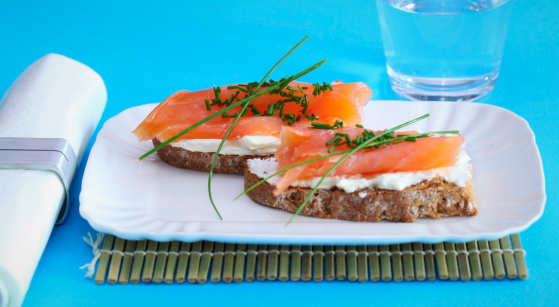 Smoked salmon on rye bread and creamed cheese with chives.