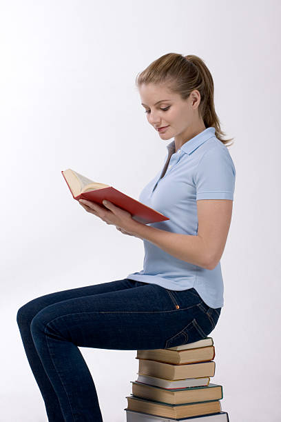 istock High school schoolgirl student reading book 153698653
