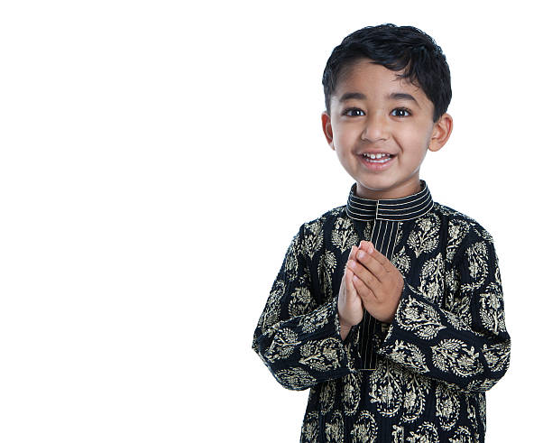 Smiling Toddler with Folded Hands Signifying Traditional Greeting, Namaste stock photo