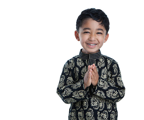 Smiling Toddler with Folded Hands Signifying Traditional Greeting, Namaste stock photo