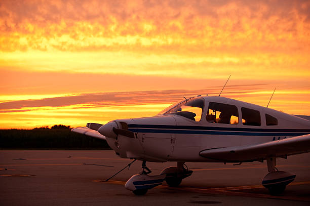 Airplane ready to fly at sunset stock photo