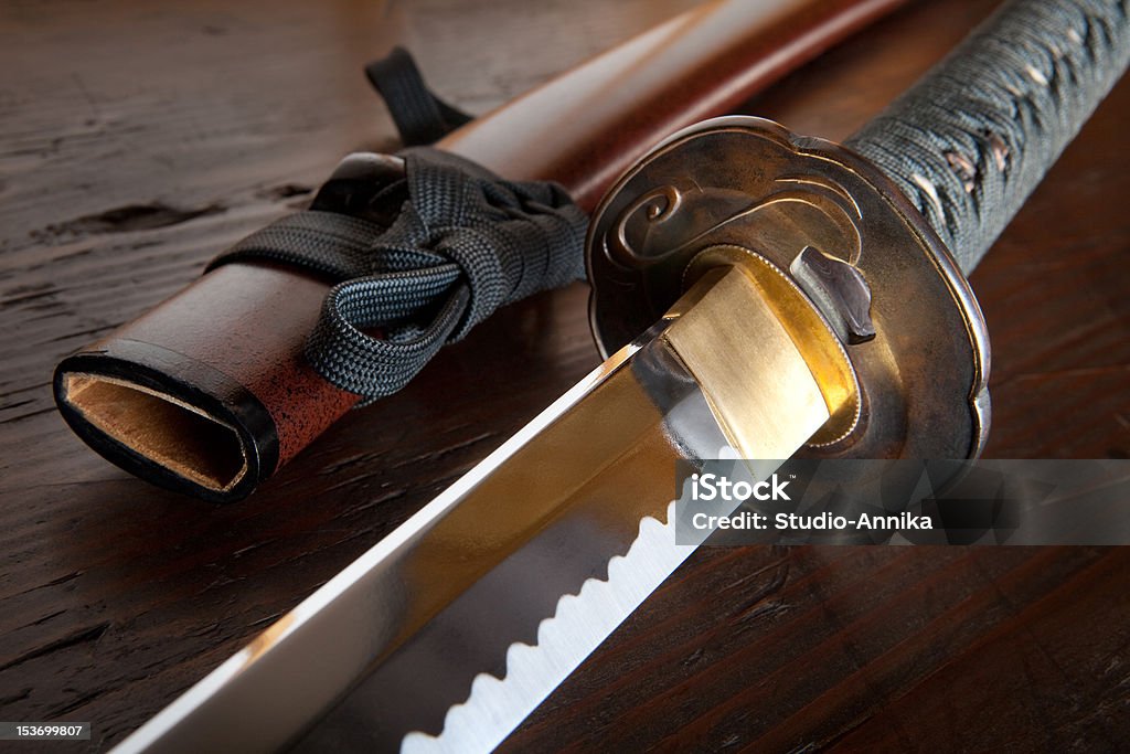 Japanese sword and sheath Real japanese samurai sword and sheath on wooden board Samurai Sword Stock Photo