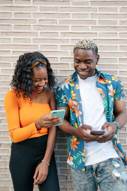 istock Young black friends using smartphone in the street 1537001934