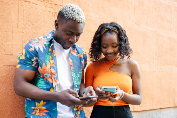 istock Young black friends using smartphone in the street 1537004068