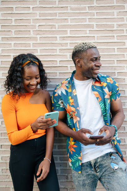 istock Young black friends using smartphone in the street 1537004561