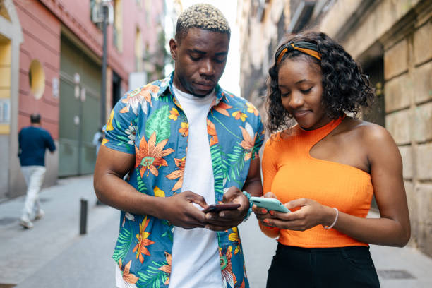istock Young black friends using smartphone in the street 1537005130