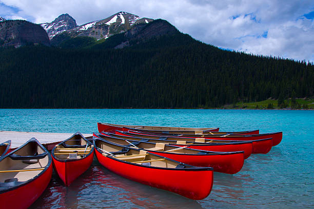 istock Orange Canoes on teal Lake 153700574