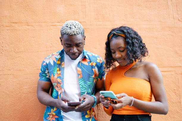 istock Young black friends using smartphone in the street 1537007707