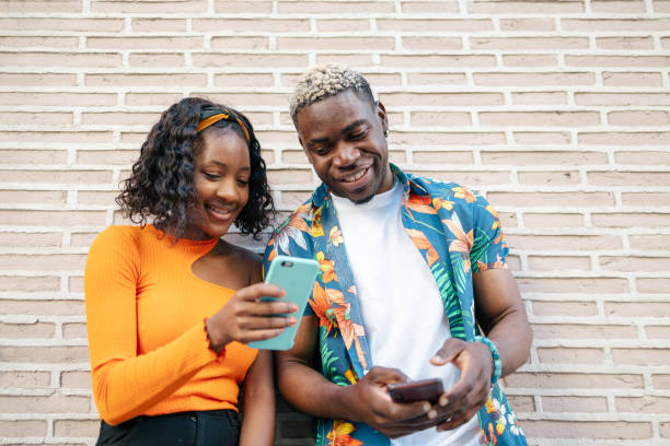 istock Young black friends using smartphone in the street 1537008230