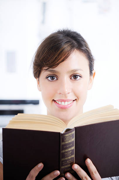 istock young woman reading book in home interior. 153700852