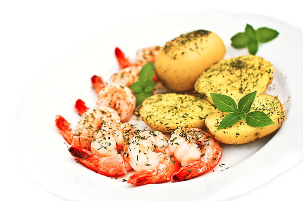 Prawns and potato on white stock photo