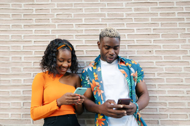 istock Young black friends using smartphone in the street 1537009123