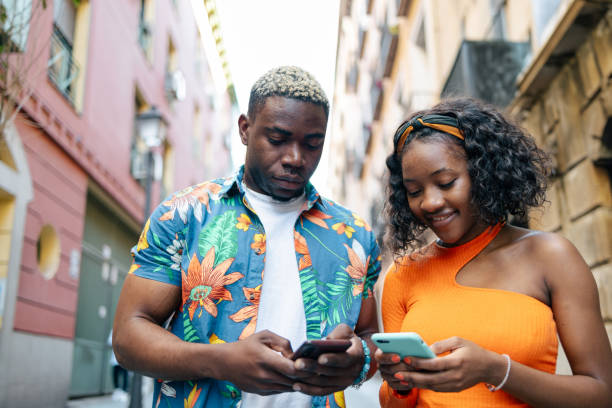 istock Young black friends using smartphone in the street 1537012899